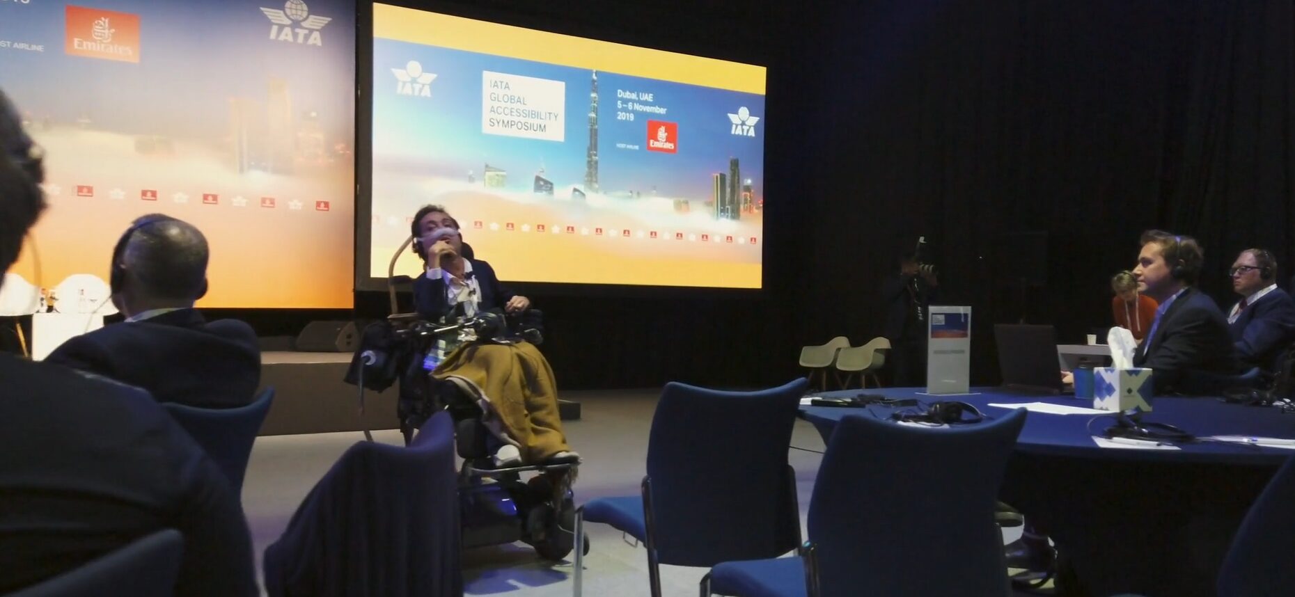 A diverse group of policymakers reviewing inclusive accessibility toolkits and digital resources together in a conference room.