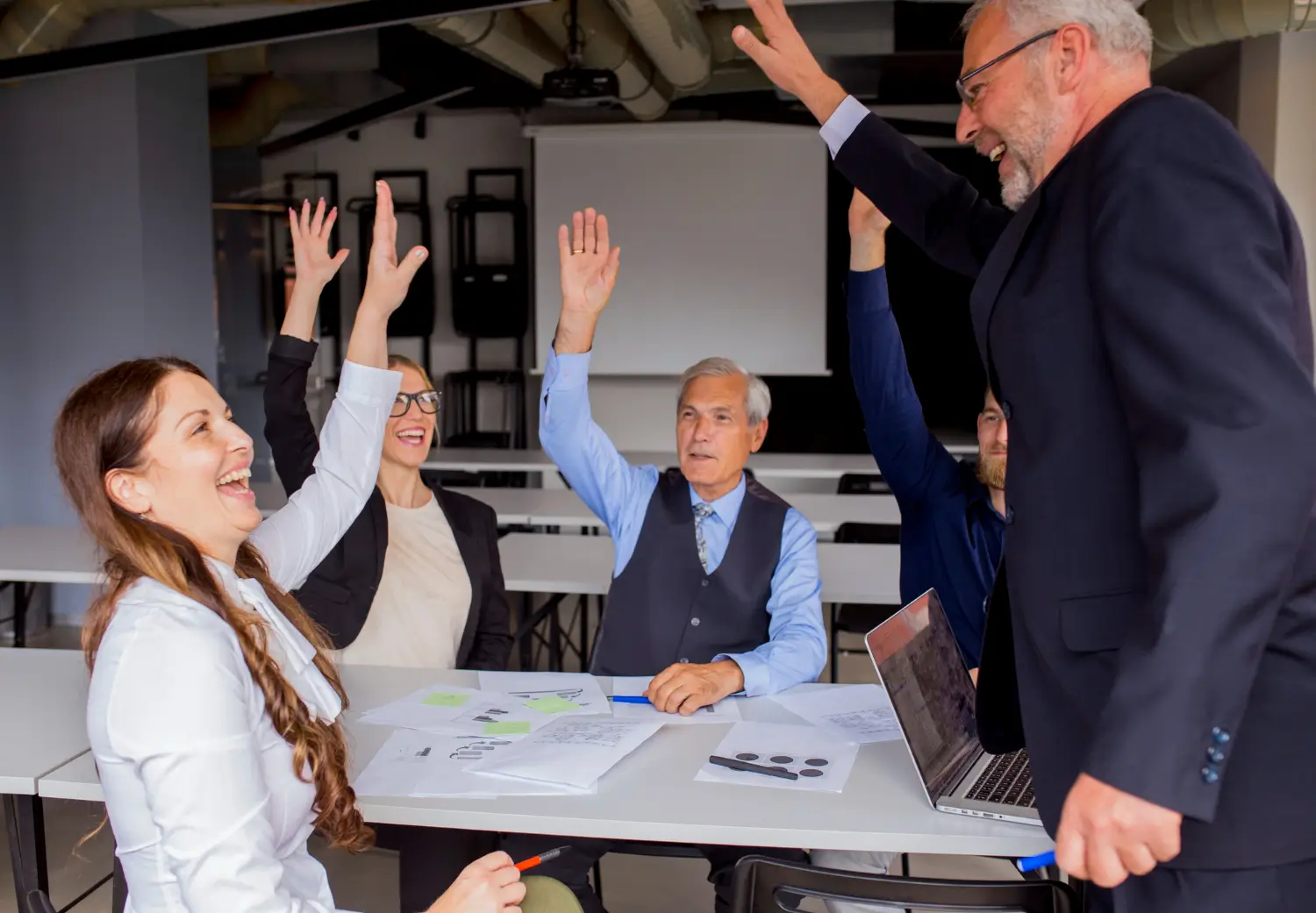 Business team celebrating together during a collaborative office meeting