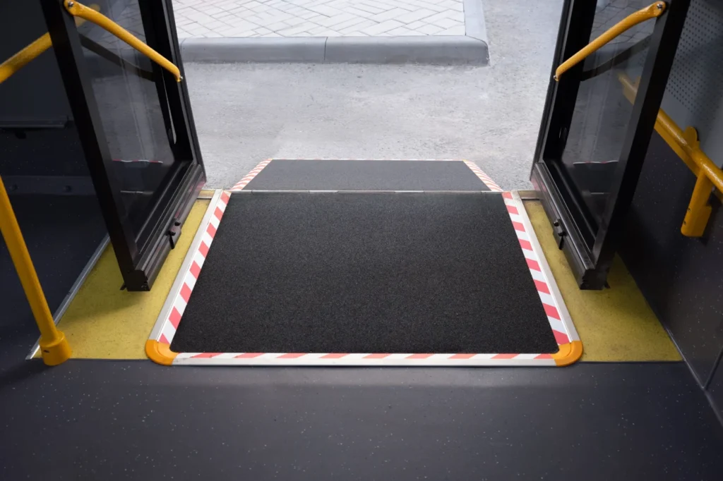 Accessible bus ramp extended at the entrance of a public transport vehicle