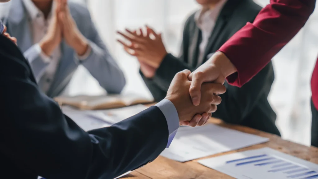 Business professionals shaking hands during a meeting