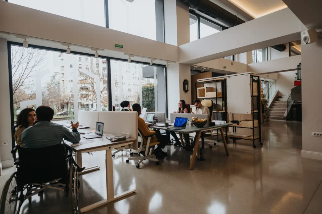 Inclusive office workspace with team members collaborating at desks